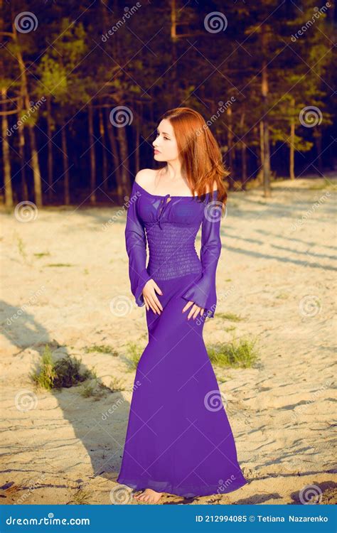 Woman In Purple Long Dress At Nature Fashionable Concept Stock Image