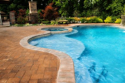Estimating the price to build a pool depends on the a small fiberglass pool costs $18,000 while a large concrete pool costs $60,000 or more. Concrete Freeform Pool with Raised Spa | Small backyard pools, Small inground pool, Backyard pool