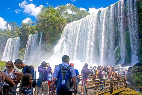 Visitors On Walkway Below Waterfalls In Iguazu Falls National Park