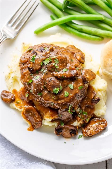 While it tastes like an absolute treat, this meal is made with a simple ground beef patty and a rich mushroom gravy. Salisbury Steak Recipe-6 - Saving Room for Dessert