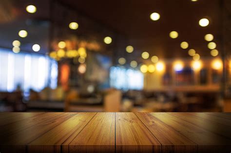 empty wooden table top  blur coffee shop  restaurant interior background stock photo