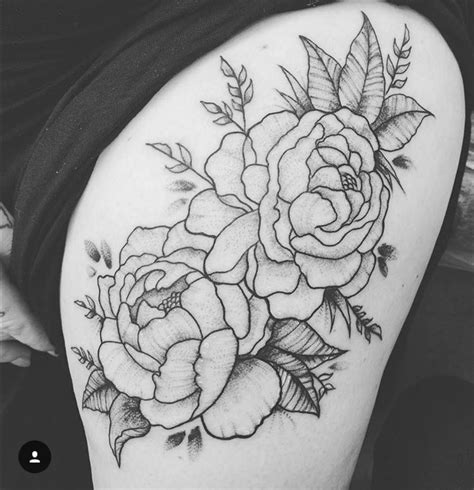 A Black And White Flower Tattoo On The Thigh