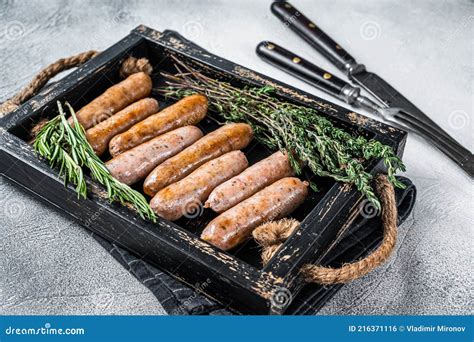 Roasted Bratwurst Hot Dog Sausages In A Wooden Tray With Herbs White