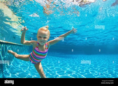 Funny Portrait Of Child Learn Swimming Diving In Blue Pool With Fun