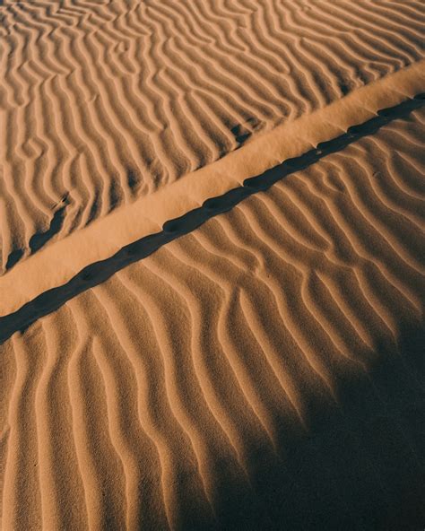 Brown Sand Dunes During Daytime Photo Free Soil Image On Unsplash