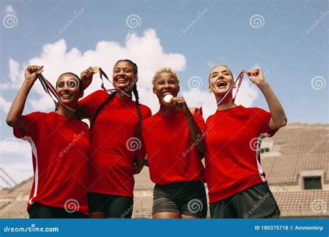 Female Football Team Celebrating The Win At Stadium Stock Photo Image