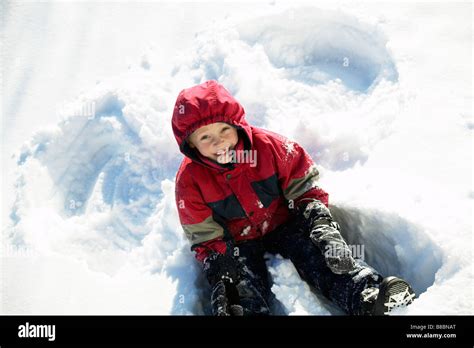 Boy Making Snow Angels Stock Photo Alamy