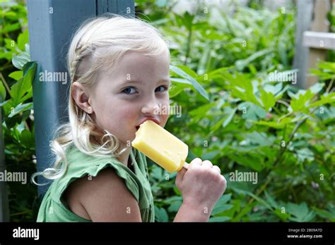 Hermosa Niña De 6 Años Comiendo Una Paleta De Frutas En Su Jardín