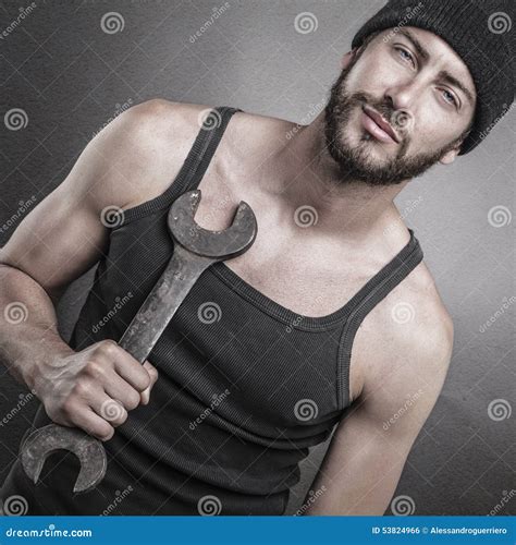 Handsome Man Standing And Holding A Wrench Stock Photo Image