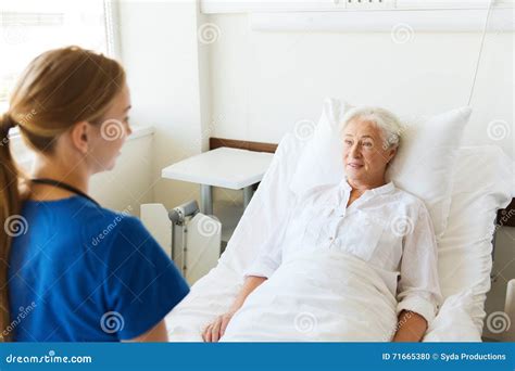 Doctor Or Nurse Visiting Senior Woman At Hospital Stock Photo Image
