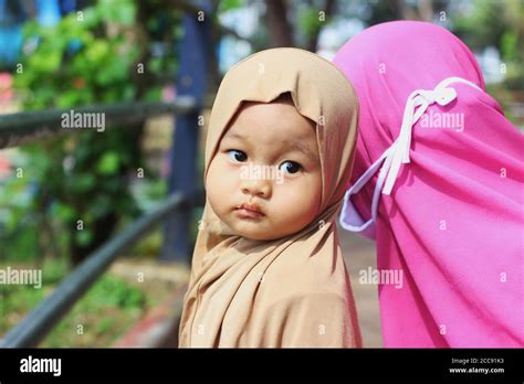 A Cute Beautiful Muslim Indonesian Baby Girl With Her Mother In The