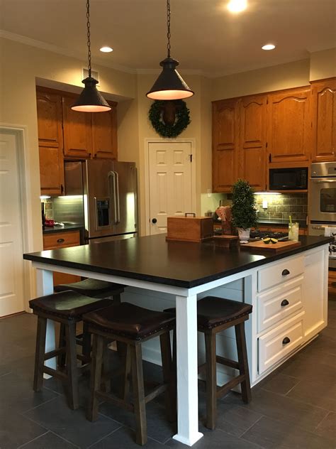 My husband would not allow any painting or staining of these cabinets under any circumstances. Updated kitchen with new white island, original honey oak cabinets, and a touch of shiplap. Love ...