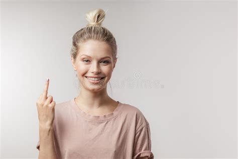 Cheerful Young Woman Finding New Idea And Raising Index Finger Up
