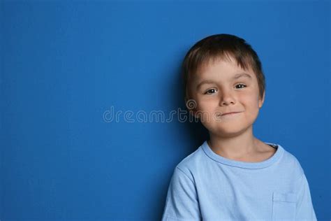 Portrait Of Cute Little Boy On Background Space For Text Stock Photo