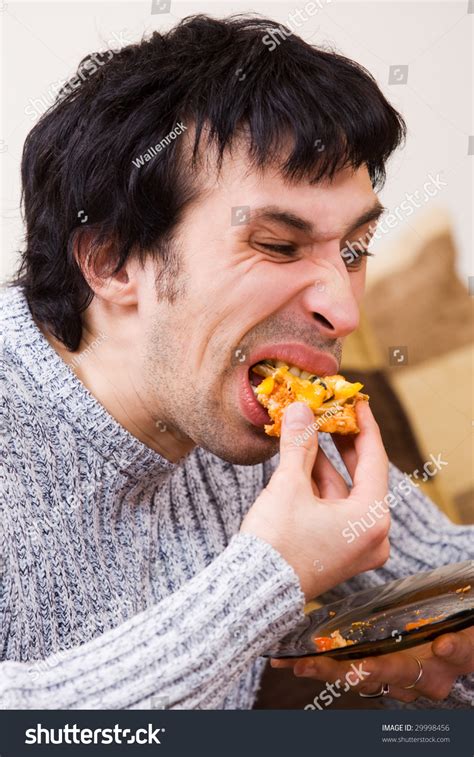 Man Eating Junk Food With Disgusting Expression Stock Photo 29998456