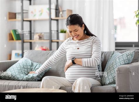 Pregnant Woman Having Labor Contractions At Home Stock Photo Alamy