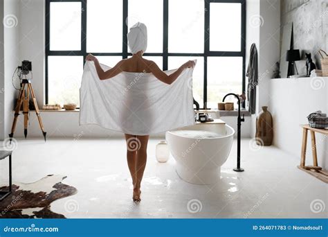 Rare View Of Woman Ready To Bathe Standing Next To Bathtub In Bathroom