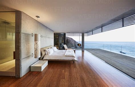 Modern Luxury Bedroom Open To Patio With Ocean View Stock Photo