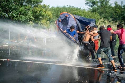 Hungarian Police Fire Tear Gas Water Cannons At Migrants On Serbian