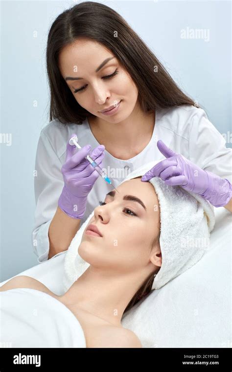 Attractive Woman Is Getting Rejuvenating Facial Injections In Beauty Salon Cosmetology Concept