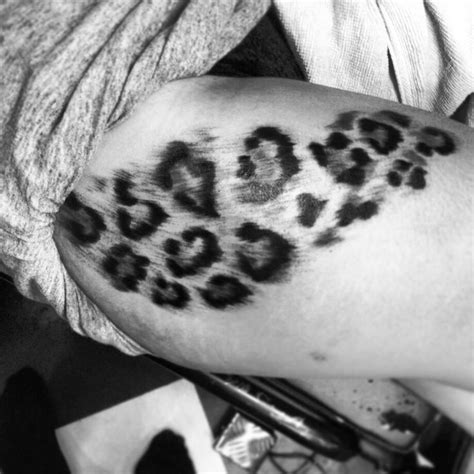 Black And White Photo Of Someones Arm With Leopard Print On It