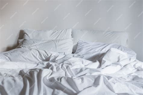 Premium Photo Close Up White Bedding Sheets And Pillow Messy Bed Concept