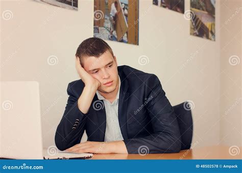 Businessman With Laptop Resting Head On Hand Stock Photo Image Of