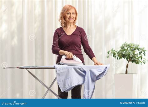 Mature Woman Ironing A Shirt And Smiling Stock Image Image Of Laundry