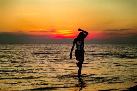 Silhouette Of A Sensual Woman At Sunrise On The Beach Body Perfect Figure Enjoying Life Stock