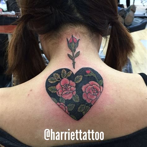 A Woman With A Tattoo On Her Back Neck And Behind The Neck Is A Heart