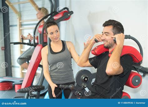 Personal Trainer Instructing Trainee In Gym Stock Photo Image Of