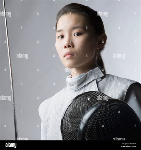 Portrait Of A Female Fencer Holding A Sword And A Fencing Mask Stock Photo Alamy