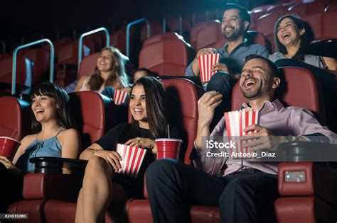 Group Of People Laughing At The Movie Theater Stock Photo Download