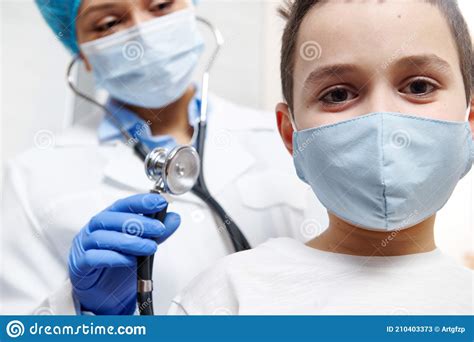Smiling Boy In Medical Mask During A Pediatrician`s Examination
