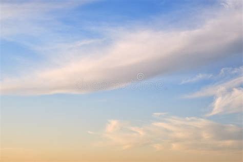 Soft Fluffy Clouds On The Warm Sunset Sky Background Stock Image
