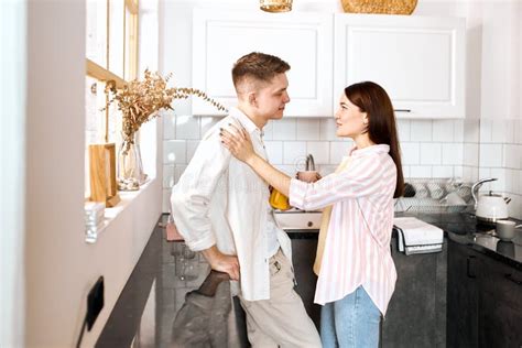 Couple Talking And Drinking Tea In Their Kitchen Stock Photo Image Of