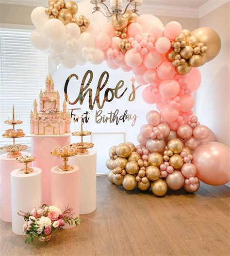 A Birthday Party With Pink And Gold Balloons Castle Cake Toppers And