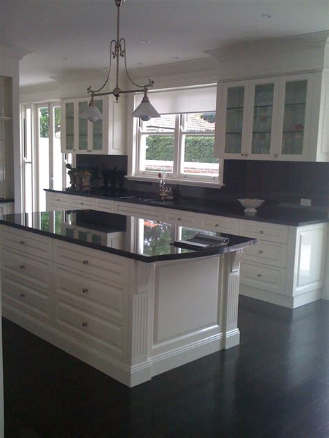 The combination of pale grey and cloudy silver set atop white cabinets will add a warm hue to your kitchen without it being too uniform. Gallery | Kitchen design, Kitchen renovation, Black countertops