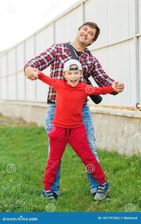 funny dad and son fooling around outdoors father with son having fun together stock image