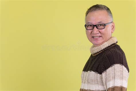 Profile View Of Happy Mature Japanese Man Looking At Camera Ready For Winter Stock Image Image