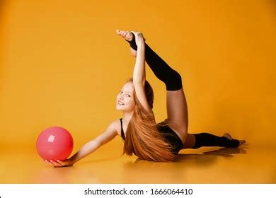 Flexible Redhead Girl Rhythmic Gymnast Stretching Stock Photo