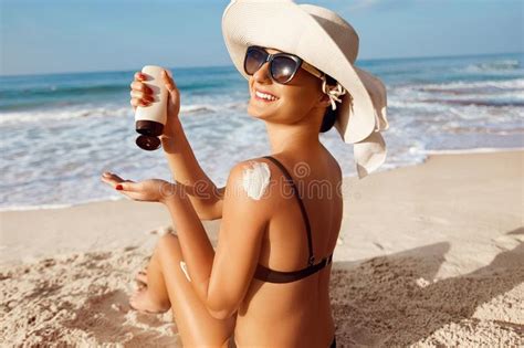 Beautiful Woman Apply Sun Cream On Tanned Back Skin And Body Care Sun Protection Stock Photo