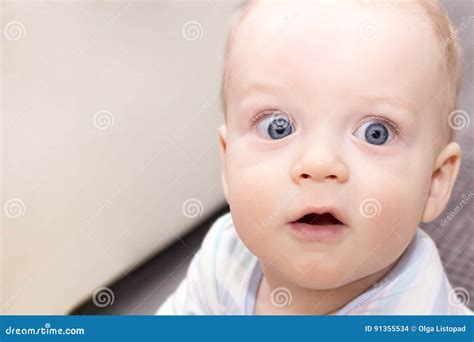 Surprised Open Eyed Baby Boy Close Up Portrait Of Blue Eyed Infant Kid