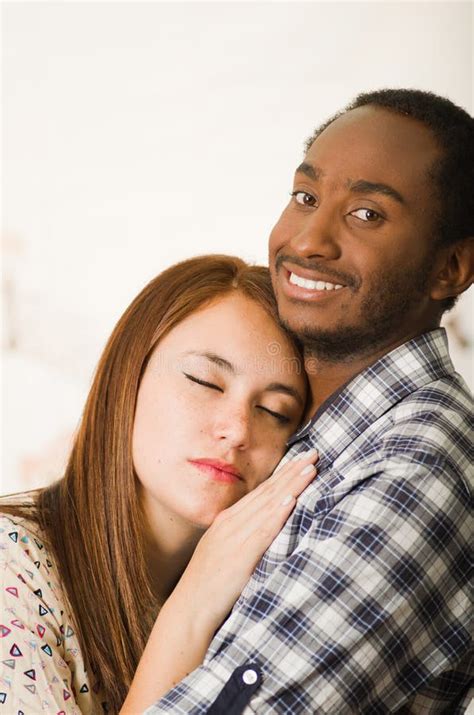 Interracial Charming Couple Wearing Casual Clothes Posing While