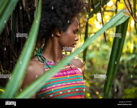 melanesian pacific islander athlete girl with afro hair sytile in the jungle half profile stock