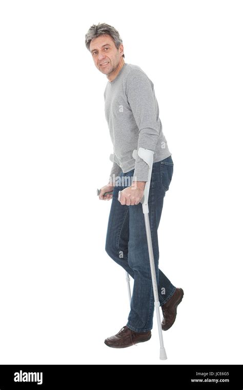 Man Walking Using Crutches Stock Photos And Man Walking Using Crutches