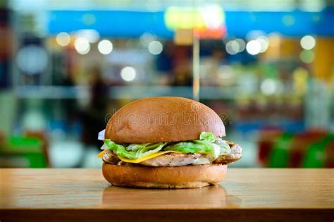 Delicious Fast Food Burger Served With Fish Cheese And Salad In Stock