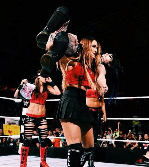 Nikki Bella Giving Paige The Rack Attack With Brie Bella Behind Her