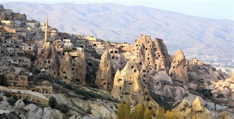 Ancient Rock Houses Intermingled With Modern Houses In Cappadocia