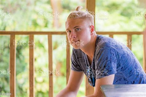 Serious Teenage Boy Sitting Watching Stock Photo Download Image Now